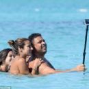 Retired footballer Ronaldo uses a selfie stick to take loved up holiday snaps in the sea with beach babe fiancé Paula Morais - 454 x 303