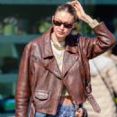 Gigi Hadid – In a brown leather jacket and carrying a MIU MIU black bag in New York