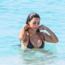 Kim Kardashian – In a black bikini in Turks and Caicos