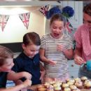 Kate's little helpers! Beaming Prince George, 8, Princess Charlotte, 7, and Prince Louis, 4, bake cakes with the Duchess of Cambridge for a Cardiff street party taking place today - 454 x 308