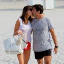 Claudia Galanti and french boyfriend Arnaud Mimran kissing beachside on Christmas day in Miami Beach