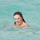 Melissa George – In white bikini on the beach in St. Barts - 454 x 303