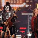 Musician Gene Simmons of KISS and American Idol Finalist Caleb Johnson perform onstage during Fox's "American Idol" XIII Finale at Nokia Theatre L.A. Live on May 21, 2014 in Los Angeles, California