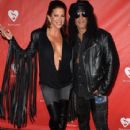 Musician Slash (R) and Perla Hudson attend the MusiCares MAP Fund Benefit Concert at Club Nokia on May 12, 2014 in Los Angeles, California - 407 x 594