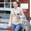 'How I Met Your Mother' star Alyson Hannigan braves the rain to pick up a cup of coffee and shop at Poppy store in the Brentwood Country Mart on October 9, 2013 in Brentwood, California