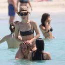 Aurora Ramazzotti – In a black bikini on holiday on the beach in Formentera - 454 x 302