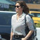 Cindy Crawford in flared jeans and a striped jumper while shopping in Malibu
