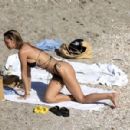 Alexis Ren – In a black bikini on the beach in St Barts - 454 x 300