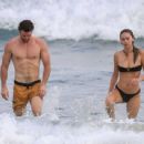 Gabriella Brooks in Black Bikini and Liam Hemsworth on the beach in Byron Bay - 454 x 342