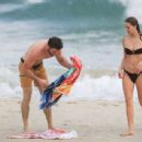 Gabriella Brooks in Black Bikini and Liam Hemsworth on the beach in Byron Bay - 454 x 344