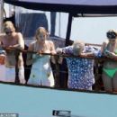 Queen's Roger Taylor uses a pole and shoots an AIRGUN at jellyfish whilst on a boat ride with his wife and children during sun-soaked holiday in Spain, 31 May 2019 - 454 x 300