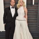 Taylor Kinney and Lady Gaga: 2016 Vanity Fair Oscar Party Hosted By Graydon Carter - Arrivals
