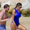 Zara McDermott – Wearing blue swimsuit on the beach in Barbados - 454 x 718