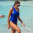 Zara McDermott – Wearing blue swimsuit on the beach in Barbados - 454 x 735