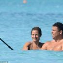 Retired footballer Ronaldo uses a selfie stick to take loved up holiday snaps in the sea with beach babe fiancé Paula Morais - 454 x 303