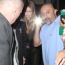 Gigi Hadid and singer Zayn Malik try to leave their hotel in New York City are are mobbed by fans and security shining flashlights April 1, 2016