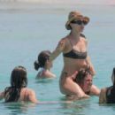 Aurora Ramazzotti – In a black bikini on holiday on the beach in Formentera - 454 x 299