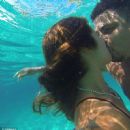 Retired footballer Ronaldo uses a selfie stick to take loved up holiday snaps in the sea with beach babe fiancé Paula Morais - 454 x 451