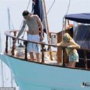 Queen's Roger Taylor uses a pole and shoots an AIRGUN at jellyfish whilst on a boat ride with his wife and children during sun-soaked holiday in Spain, 31 May 2019 - 454 x 312