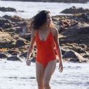 Minnie Driver in Orange Swimsuit on the beach in Malibu