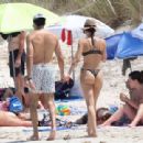 Aurora Ramazzotti – In a black bikini on holiday on the beach in Formentera - 454 x 311