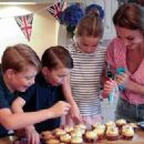 Kate's little helpers! Beaming Prince George, 8, Princess Charlotte, 7, and Prince Louis, 4, bake cakes with the Duchess of Cambridge for a Cardiff street party taking place today - 454 x 326