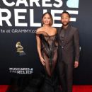 John Legend wears Louis Vuitton and Christy Teigen wears Christian Siriano - 2025 Grammy Awards