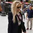 Kate Hudson wears a chic black suit worn over a vintage MTV T-shirt as she leaves Paris