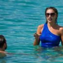 Zara McDermott – Wearing blue swimsuit on the beach in Barbados - 454 x 308