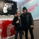 Gene Simmons poses in front of his acrylic on canvas work 