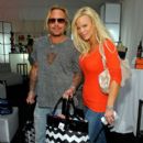 Musician Vince Neil (L) and wife Lia Gherardini pose in the Official Silver Spoon Gifting Lounge held during the 2008 American Music Awards at the Nokia Theatre on November 22, 2008 in Los Angeles, California. - 398 x 594