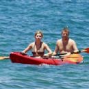 Jennette McCurdy wearing a pretty bikini and board shorts was spotted kayaking with a male friend in Maui