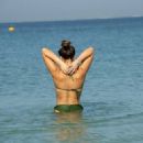 Amy Willerton – In a green bikini on the beach in Dubai - 454 x 323