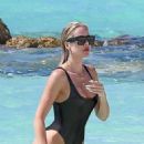 Khloe Kardashian – Spotted in a black one piece while in Turks and Caicos