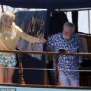 Queen's Roger Taylor uses a pole and shoots an AIRGUN at jellyfish whilst on a boat ride with his wife and children during sun-soaked holiday in Spain, 31 May 2019 - 454 x 320