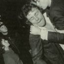 Claude being restrained by a friend as the LAPD riot