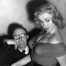 Glamour model and actress Sabrina seated on the knee of Arthur Askey - 454 x 588