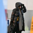 Madonna bundles up in a puffy black coat at JFK Airport in New York
