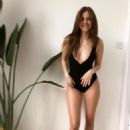 Barbara Palvin flaunts her cleavage and enviably long legs in a plunging black swimsuit for sizzling snapshot
