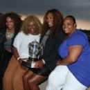 Serena Williams, her mother Oracene Price, her sisters Lyndrea Price and Isha Price pose with the French Open trophy on the Pont Bir Hakeim, in front of the Eiffel Tower in Paris. Serena Williams of USA beat Maria Sharapova of Russia in 2 sets to win the