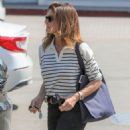 Cindy Crawford in flared jeans and a striped jumper while shopping in Malibu