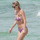 Baskin Champion in Purple Bikini at the beach in Miami