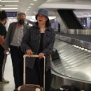 Jennifer Tilly – Waiting for her luggage after her flight into Los Angeles at LAX - 454 x 681