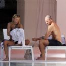 Arabella Chi – Seen by the pool with a mystery male friend in Ibiza - 454 x 347