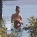 Chrissy Teigen – Seen by a swimming pool in Lake Como - 454 x 303