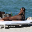 Kelly Rowland – In a black bikini at the beach in Miami