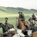 Button (Diego Luna, left), Charley Waite (Kevin Costner, center), and Mose Harrison (Abraham Benrubi, right) drive cattle on the open range, the one place where a man can be free.