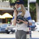 Suki Waterhouse – In grey leggings chats on her phone in Beverly Hills
