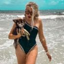 Electra Mustaine in a black swimsuit with her dog Romeo - 454 x 567