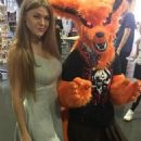 Viola Bailey (Violeta Jurgis Arturovna) poses in a gray dress near a Kurama cosplay from the Naruto manga - Instagram - August 10, 2018